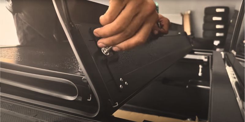 A technician installing Toyota tacoma tonneau cover